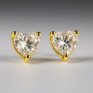 Elegant heart-shaped stud earrings in a shimmering gold tone.